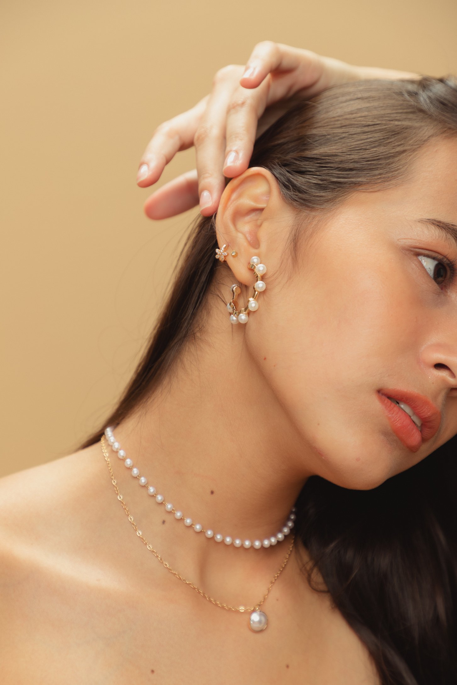 Woman with Pearl and Gold Necklace and Earrings